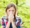 woman sneezing because of summertime allergies