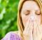 Allergy Medicine - Woman blowing her nose outside