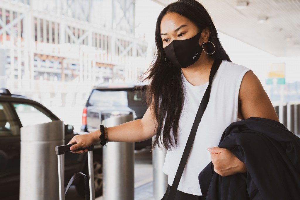 woman traveling with mask