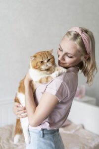 Woman hugging cat